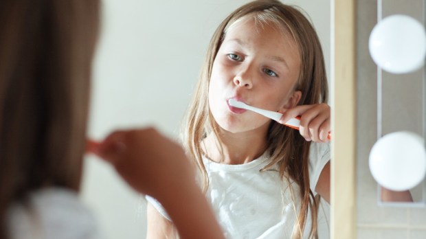 little-girl-brushes-teeth-in-the-bathroom-147799700shutterstock_147799700.jpg