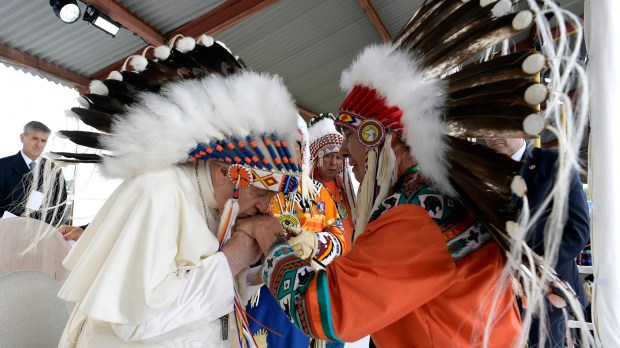 Pope Francis wearing a headdress Indigenous leaders at Muskwa Park in Maskwacis, Edmonton