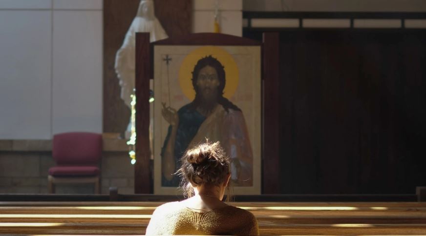 woman praying church