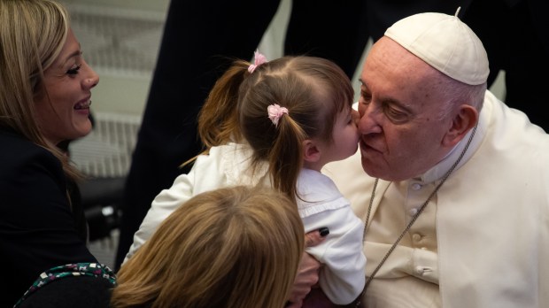 A little girl kisses Pope Francis