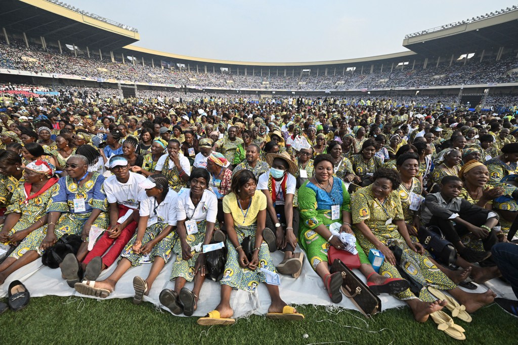 Pope-Francis-waves-as-he-arrives-by-popemobile-for-a-meeting-with-young-people-and-catechists-at-Martyrs-Stadium-in-Kinshasa-AFP