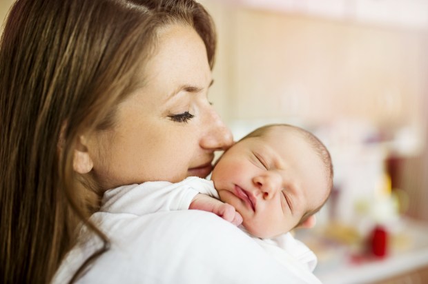 young mom holding newborn